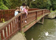 A family playing pooh sticks in Goring